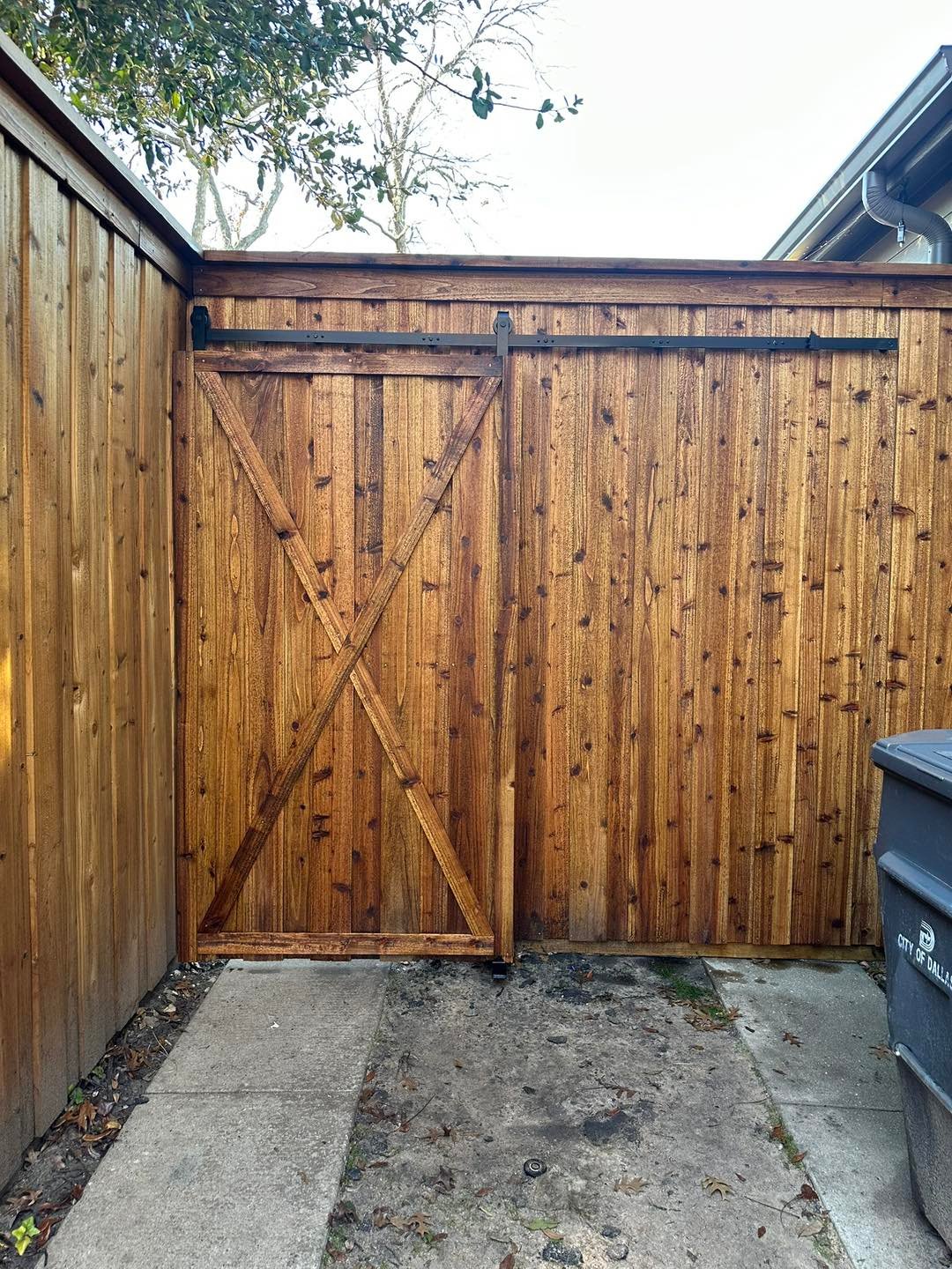 custom fence construction with barn door