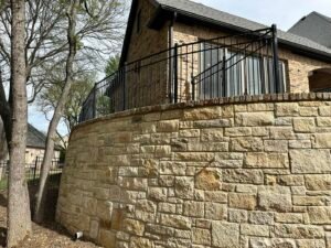 iron privacy fence on retaining wall
