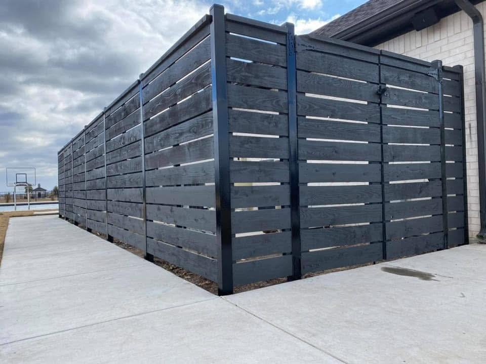 privacy fence with black wood and metal posts