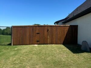 beautiful dark stained fence with black gate hardware